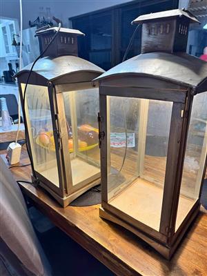 Set of rustic look lanterns in steel and glass with electric light