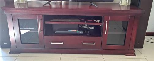 Large, solid mahogany TV unit with glass doors, big draw at the bottom