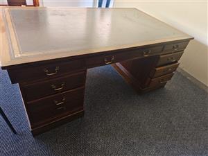 Vintage Mahogany pedestal desk, featuring a leather top and multiple drawers.