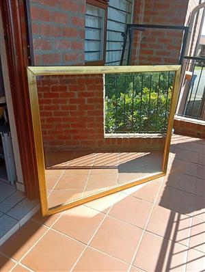 Large 110cm x 130cm golden framed mirror.