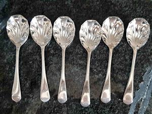 Vintage dessert spoons featuring a distinctive shell-shaped bowl design.