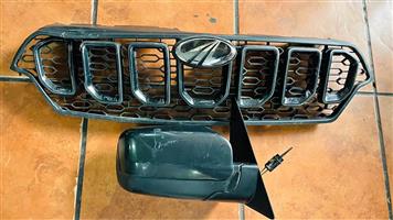 Mahindra Scorpio front grill and a side-view mirror.