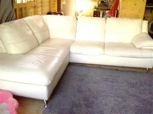 I am selling a large, cream, L-shaped couch in need of tlc.