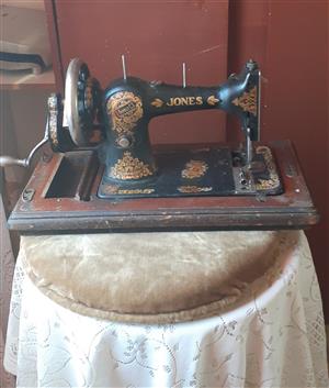 Jones family C.S Antique hand crank sewing machine in working condition and cas 