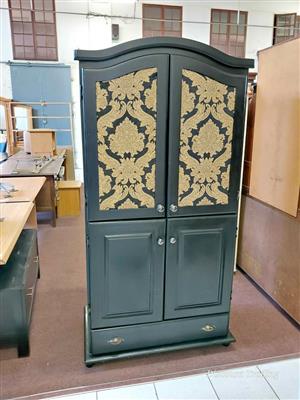 Wooden armoire (wardrobe), beautifully finished in a matte black paint with gold damask wallpapered