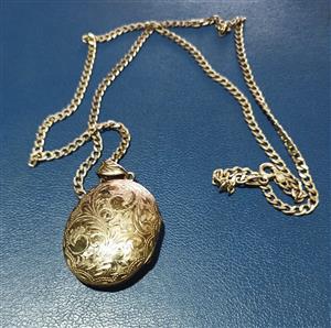 Silver pendant with silver chain.