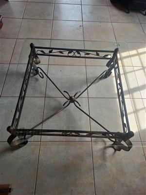 Wrought-iron coffee table with glass top.