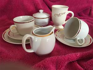 12 piece cup and tea set and 12 matching coffee mugs.