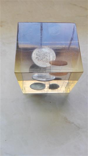 Old coins, uncirculated, in glass box