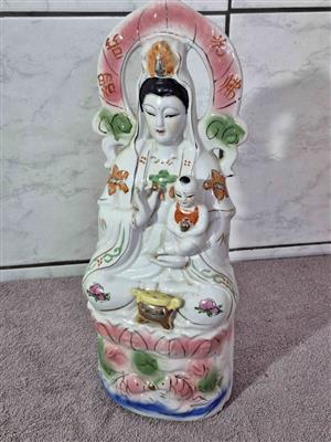 Vintage porcelain statue of Guanyin (also known as Kwan Yin), Goddess of Mercy and Compassion