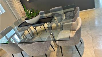 10 seater custom made tempered glass top table with silver metal legs. Size 2.20m x1.70m.No Chairs