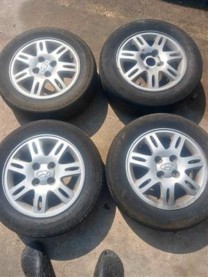 Set of original 14 inch Hyundai mag wheels with tyres for sell 