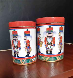 2 x Round, vintage-style Christmas nutcracker tin containers.