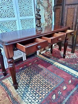 Classic Dark‑Wood Writing Desk with Three Drawers and Turned Legs