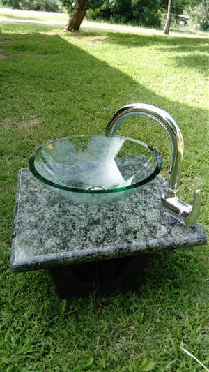 Glas basin and tap mounted on granite top