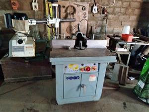 Industrial Spindle with blocks and cutters. Sliding table. Feeder.