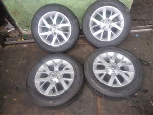 15inch Nissan Almera original mags with used 185/65/15 tyres set for 