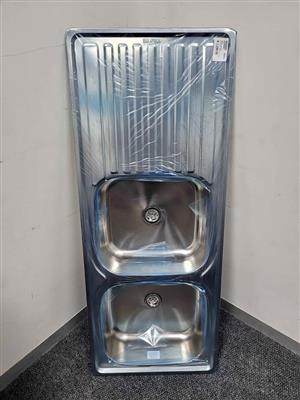 stainless steel double bowl sink with a drainer