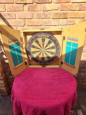 Dartboard complete in wooden cabinet for sale. Unicorn