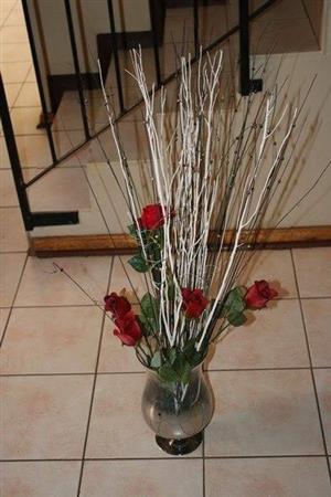 Glass flower vase with fake flowers