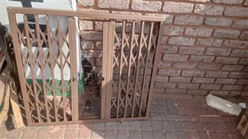 Retractable Trellis Window Security Gate, brown steel, no key.