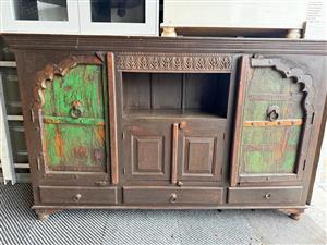 Rustic wooden buffet with green inlay doors and wooden latches