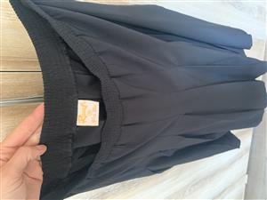 Black pleated skirt, soft fabric, size 38