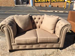 2 seater beige couch 