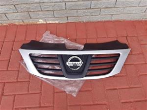 NP200 GRILL WITH A BADGE ON . GENUINE. BRAND NEW. FOR VARIOUS OTHER CARS TOO.
