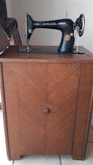 Antique Singer sewing machine in its vintage cupboard