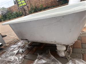  vintage freestanding cast-iron bathtub with decorative pedestal feet,