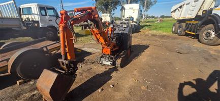 Mini excavator in good working condition on rubber tracks comes with trailer .