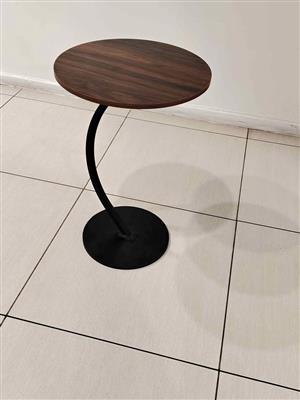 Brown and black side table with metal curved leg
