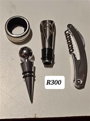 Wine bottle stopper, wine pourer, corkscrew and wine bottle drip ring