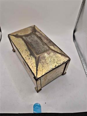 Vintage or antique metal box, likely made of brass or copper, possibly used as a trinket box