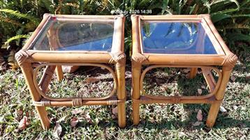 Set of two vintage Cane side tables with glass tops