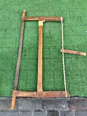 Bow saw with twisted rope and toggle mechanism