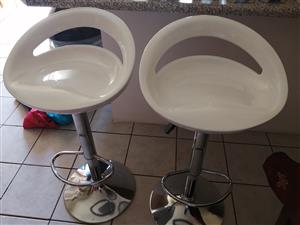 2 white bar chairs 