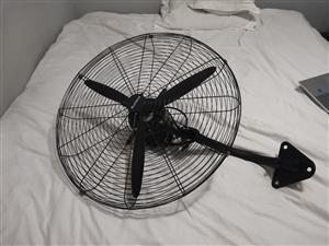 Wall-mounted industrial fan.