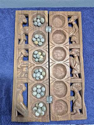 Vintage handcrafted wooden Mancala board, a traditional strategy game popular across Africa