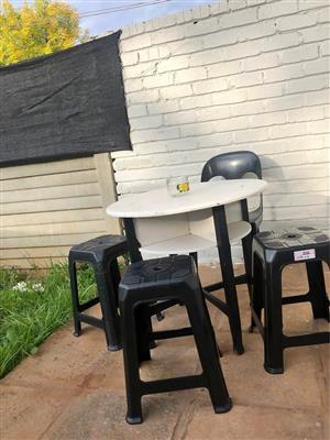 Outdoor wood table with four plastic chairs all great condition