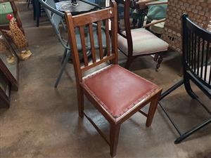 Antique, oak chair with padded, leather seat