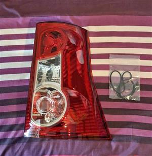 Nissan Np200 rear tail lamp cover - right side/driver side.