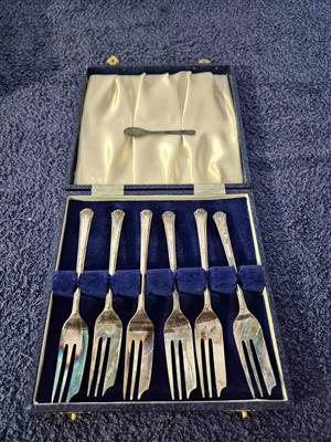 A set of vintage silver-plated cake forks