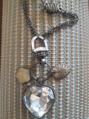 Preloved heart pendant necklace with a etched heart and flower stone designhape.