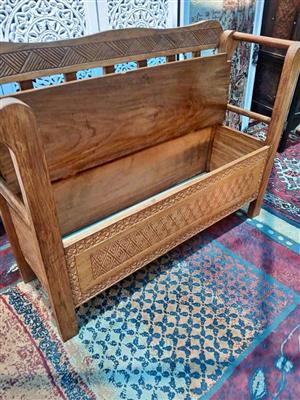 Hand‑carved Wooden Bench with Geometric Patterns and Armrests