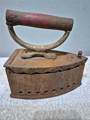 Vintage coal-heated flat iron, also known as a charcoal iron, sad iron, or smoothing iron