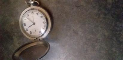 Second hand pocket watch with chain in good working condition.