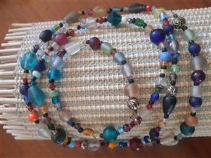 A colorful beaded necklace with many lovely bright colors.