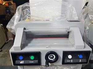 Office guillotine cuts a stack of paper A4